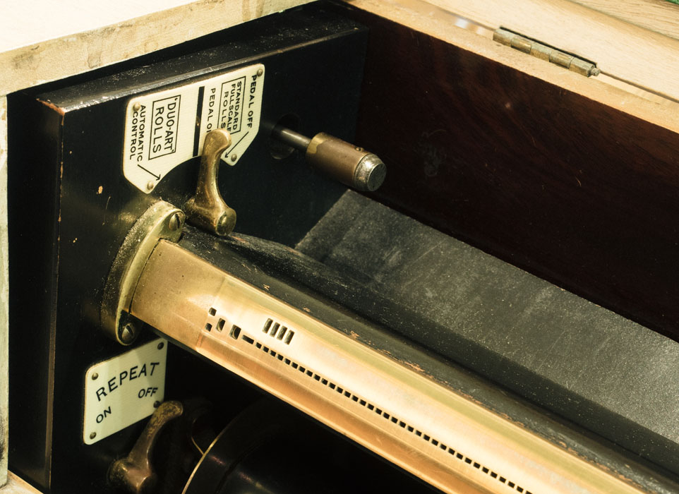 Player piano register bar which 'reads' the holes in the paper roll as notes